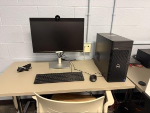 Desktop computer with a large tower, monitor, and attached keyboard and mouse on a table.